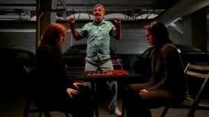 Mr._Burt_dances_as_Dana_Scully_and_Monica_Reyes_play_checkers
