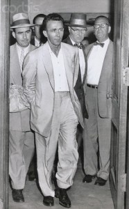 01 Sep 1955, Manhattan, New York City, New York State, USA --- Original caption: New York: Gunman Elmer "Trigger" Burke, who was returned to New York September 1st to face federal charges of fleeing to avoid prosecution after being captured last week in Charleston, North Carolina, leaves the federal courthouse in Foley Square under heavy guard after being turned over to city police by the federal authorities. Burke faces New York state charges of murder. --- Image by © Bettmann/CORBIS